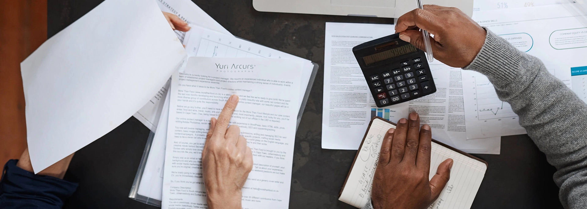 Bracewell Tax practice banner image, which shows two people reviewing documents and doing calculation.